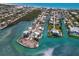 Stunning aerial view of waterfront homes with private docks and boats on a sunny day near a sandy beach at 619 Bayview Dr, Longboat Key, FL 34228