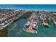 Breathtaking aerial shot capturing the community's canal-front homes, clear blue waters, and beach in the distance at 619 Bayview Dr, Longboat Key, FL 34228