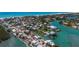 Aerial view featuring pristine waterfront homes along canals, showcasing luxury living and convenient boat access at 619 Bayview Dr, Longboat Key, FL 34228