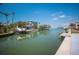 Stunning waterfront property featuring a private dock, boat lift, and lush tropical landscaping at 619 Bayview Dr, Longboat Key, FL 34228