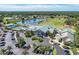 An aerial view of the community, featuring a lake, golf course, clubhouse, and surrounding homes at 6503 Fairway Gardens Dr # 20-201, Bradenton, FL 34203