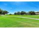 Expansive golf course view with lush green fairways, mature trees, and clear blue skies at 6503 Fairway Gardens Dr # 20-201, Bradenton, FL 34203