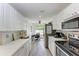 Well-lit modern kitchen with white cabinetry and stainless steel appliances at 6503 Fairway Gardens Dr # 20-201, Bradenton, FL 34203