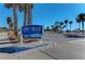 Lido Beach sign with palm trees under a blue sky, marking the North Entrance to the pool and pavilion at 6503 Fairway Gardens Dr # 20-201, Bradenton, FL 34203