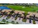 An aerial view of elegant townhomes, showcasing manicured lawns, serene ponds, and the adjacent golf course at 6708 Grand Estuary Trl # 104, Bradenton, FL 34212