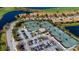 This aerial view shows well maintained tennis courts near a lake, pool and clubhouse at 6708 Grand Estuary Trl # 104, Bradenton, FL 34212
