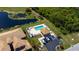 An aerial view of the community pool area, showing its proximity to nearby residences and lush landscaping at 6708 Grand Estuary Trl # 104, Bradenton, FL 34212