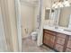 Clean bathroom with a toilet, single sink vanity with storage, and neutral tiling at 6708 Grand Estuary Trl # 104, Bradenton, FL 34212