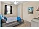This bedroom features a ceiling fan, comfortable bed with pillows, and a window with sheer curtains at 6708 Grand Estuary Trl # 104, Bradenton, FL 34212