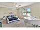 Modern bedroom with minimalist decor, a platform bed, and a large window offering natural light at 6708 Grand Estuary Trl # 104, Bradenton, FL 34212
