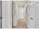 Bright hallway with tile flooring and multiple doors leading to various rooms in the home at 6708 Grand Estuary Trl # 104, Bradenton, FL 34212
