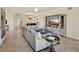 Open-concept living room with comfortable seating, a modern entertainment center, and stylish decor at 6708 Grand Estuary Trl # 104, Bradenton, FL 34212
