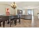 Open-concept living room with neutral walls, tile flooring, complemented by a large sofa and piano at 6708 Grand Estuary Trl # 104, Bradenton, FL 34212