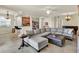 Spacious living room with tile floors, a comfortable sectional sofa, and an open floor plan at 6708 Grand Estuary Trl # 104, Bradenton, FL 34212