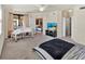 Bright main bedroom with a modern bed frame, a piano, and access to the outdoor balcony at 6708 Grand Estuary Trl # 104, Bradenton, FL 34212