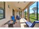 This screened in patio is furnished with rocking chairs and lounge chairs overlooking a golf course at 6708 Grand Estuary Trl # 104, Bradenton, FL 34212