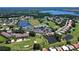Aerial view of the golf course community featuring a clubhouse, golf course and lake at 6912 Drewrys Blf # 608, Bradenton, FL 34203