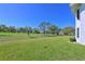 Expansive backyard with lush green grass and mature trees, next to the golf course at 6912 Drewrys Blf # 608, Bradenton, FL 34203