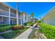 Charming two-story condo featuring beautifully maintained walkway and tropical foliage, ideal for peaceful Florida living at 6912 Drewrys Blf # 608, Bradenton, FL 34203