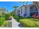Inviting two-story condo featuring lush landscaping and a well-maintained walkway, perfect for enjoying the Florida sunshine at 6912 Drewrys Blf # 608, Bradenton, FL 34203