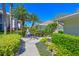 Scenic walkway lined with tropical plants, leading to charming residences, perfect for leisurely strolls in a serene community at 6912 Drewrys Blf # 608, Bradenton, FL 34203