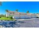View of complex garages with meticulously kept lawns, vibrant shrubbery, and accessible parking, a perfect residential community at 6912 Drewrys Blf # 608, Bradenton, FL 34203