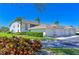 View of complex garages with meticulously kept lawns, vibrant shrubbery, and accessible parking, a perfect residential community at 6912 Drewrys Blf # 608, Bradenton, FL 34203
