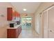 Additional view of the kitchen, featuring abundant cabinet space and access to the screened lanai at 6912 Drewrys Blf # 608, Bradenton, FL 34203