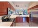 Modern kitchen with stainless steel appliances, granite countertops, and open layout to the dining area at 6912 Drewrys Blf # 608, Bradenton, FL 34203