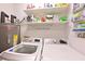 Laundry room with modern washer and dryer, ample shelving, and a water heater at 6912 Drewrys Blf # 608, Bradenton, FL 34203