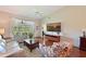 Bright living room boasting hardwood floors, vaulted ceilings, a ceiling fan, access to the lanai, and comfortable seating at 6912 Drewrys Blf # 608, Bradenton, FL 34203
