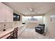 Home office with built-in desk, cabinets, and comfortable seating, perfect for remote work at 6912 Drewrys Blf # 608, Bradenton, FL 34203