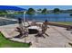 Outdoor seating area with a lakeside view and a fire pit for residents to enjoy in the evenings at 6912 Drewrys Blf # 608, Bradenton, FL 34203