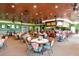 The warm restaurant features tables with chairs and a bar for residents to enjoy at the community clubhouse at 6912 Drewrys Blf # 608, Bradenton, FL 34203
