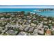Stunning aerial view showcasing the coastal neighborhood, nearby beach, and clear blue ocean waters at 710 Fox St, Longboat Key, FL 34228