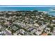 An aerial shot displays the beautiful homes, tropical trees, and inviting streets of the neighborhood at 710 Fox St, Longboat Key, FL 34228