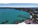 Aerial view of waterfront property with docks, parking and clear blue ocean water and beach front access at 710 Fox St, Longboat Key, FL 34228