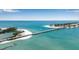 An aerial view displaying the bridge and nearby beach with clear turquoise waters at 710 Fox St, Longboat Key, FL 34228