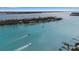 Waterfront aerial view featuring boats and nearby islands in clear turquoise waters at 710 Fox St, Longboat Key, FL 34228