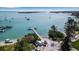 Aerial view of waterfront property featuring boat docks, parking and tranquil ocean waters on a bright sunny day at 710 Fox St, Longboat Key, FL 34228