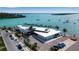 Aerial view of bayside commercial property with palm trees and modern architecture near docks, parking and tranquil ocean waters at 710 Fox St, Longboat Key, FL 34228