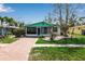 Beautiful home featuring a quaint front porch, well-manicured lawn, and a lovely brick driveway at 710 Fox St, Longboat Key, FL 34228