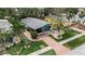 Charming home with a screened-in porch, brick pathway, lush landscaping, and inviting curb appeal at 710 Fox St, Longboat Key, FL 34228