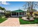 Charming home with brick driveway, screened porch, well-maintained lawn, and lush landscaping at 710 Fox St, Longboat Key, FL 34228