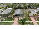 Well-maintained front yard with lush landscaping, a brick pathway, and mature trees at 710 Fox St, Longboat Key, FL 34228