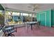 Enjoy outdoor living on this screened patio, complete with dining set and fan at 710 Fox St, Longboat Key, FL 34228