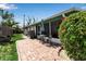 Outdoor patio featuring a dining set, lush greenery, and access to the screened porch at 710 Fox St, Longboat Key, FL 34228