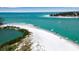 Gorgeous waterfront view with boats and white sandy beach, inviting for boating and beachside activities at 710 Fox St, Longboat Key, FL 34228