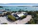 Stunning waterfront view featuring a building with ample parking and gorgeous surrounding trees at 710 Fox St, Longboat Key, FL 34228