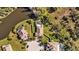 Aerial view of a home with a screened pool area and fenced yard beside a pond at 7112 46Th E Ct, Ellenton, FL 34222